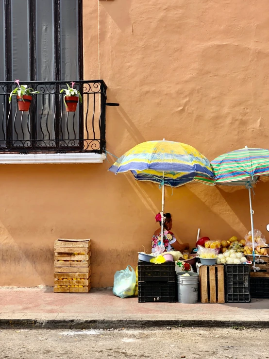 an open umbrella is above crates and boxes