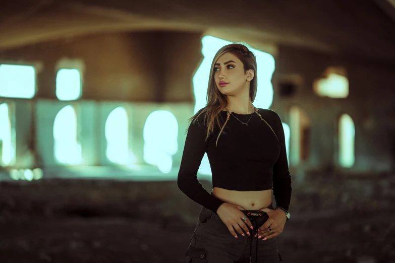 woman standing with arms crossed in an abandoned warehouse