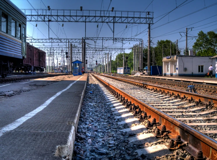 an old train track with a blue sky above it