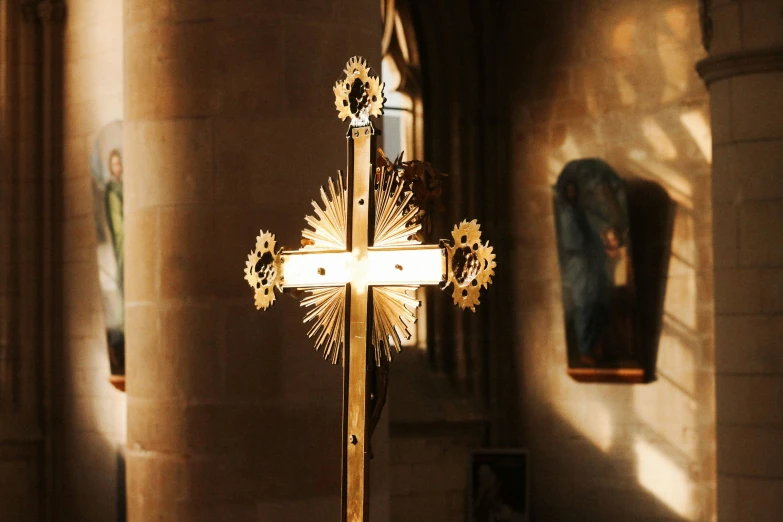 a large golden cross hanging in the church