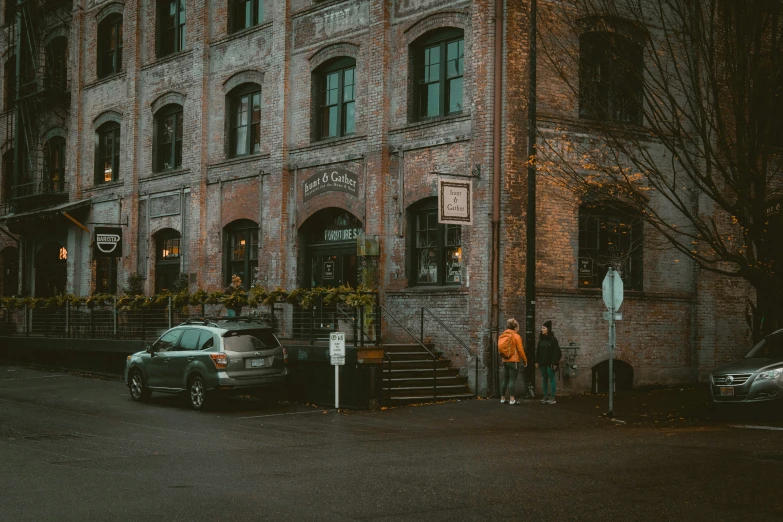 the two men are standing in front of a large building