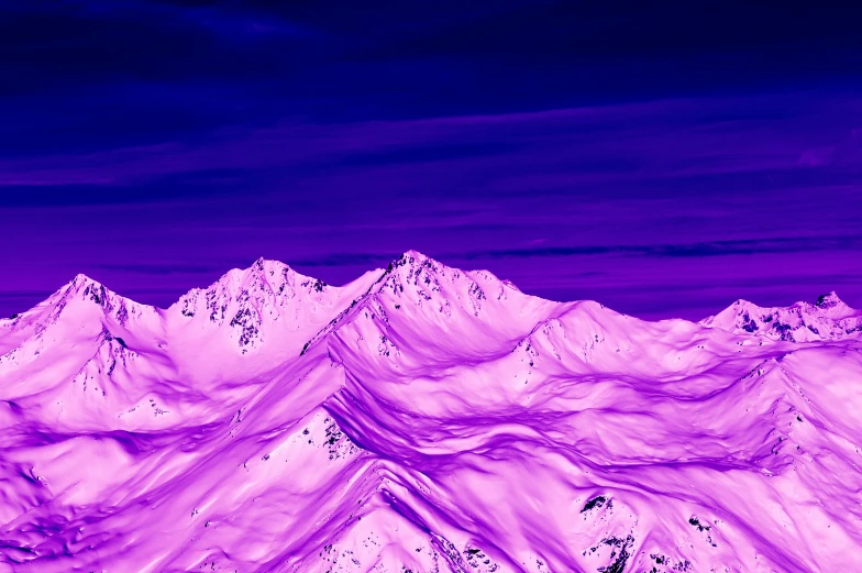 a purple sky and white mountains are seen