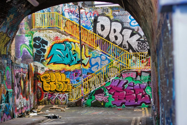 an tunnel with a number of different graffiti on it