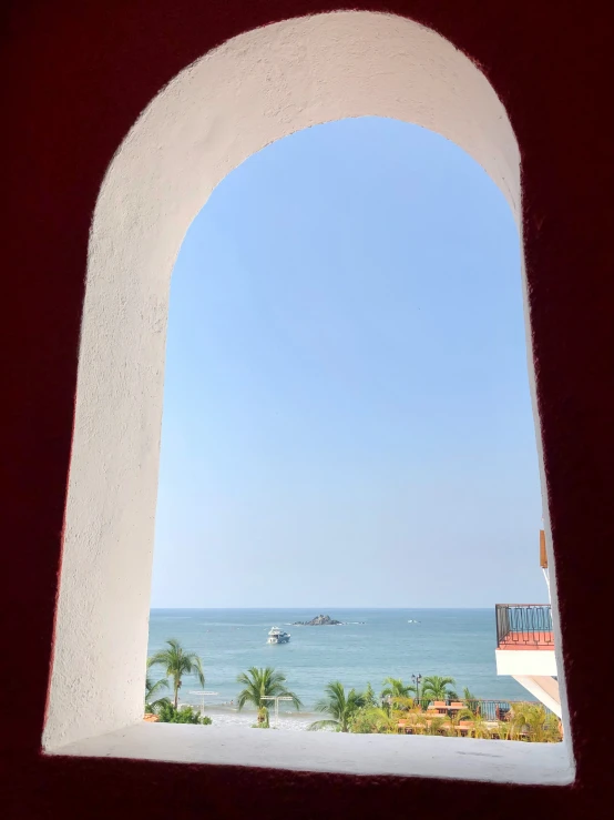 a view out of an arch into the ocean