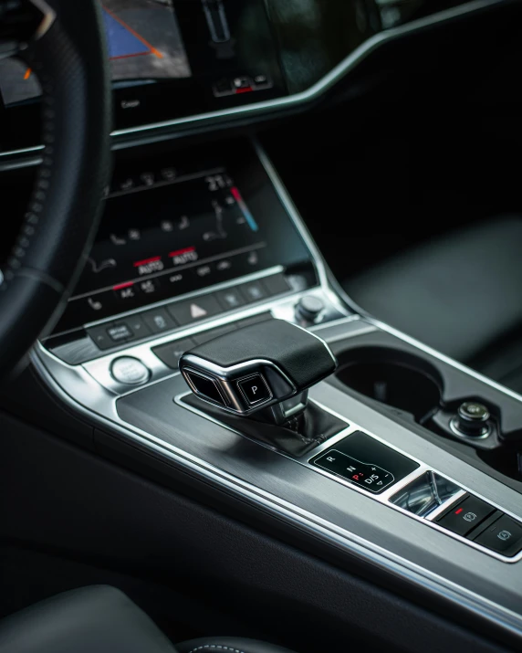 a car dashboard with various electronic controls including a steering wheel