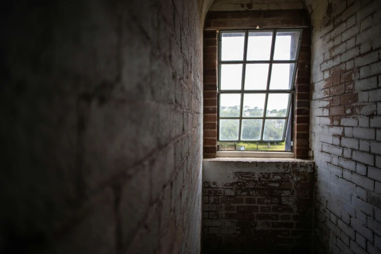 a brick wall with a window in it