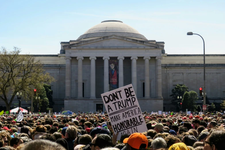 a huge crowd outside a building during the day