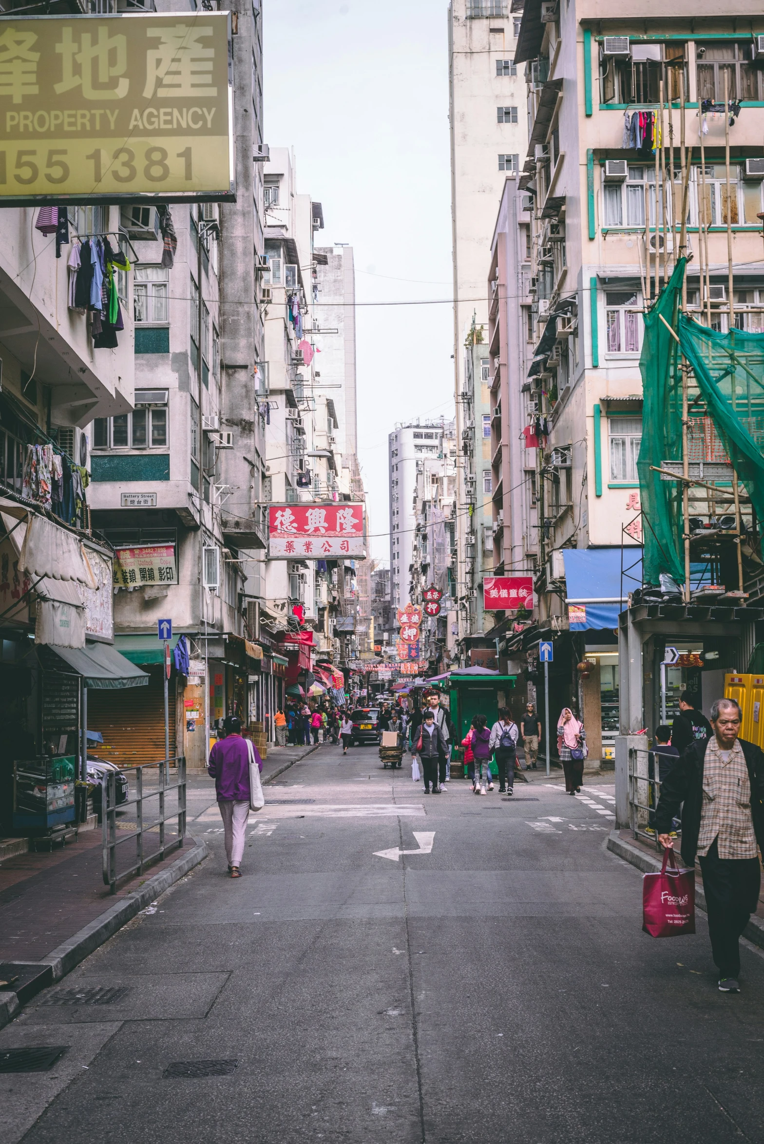 there is a very narrow street with buildings in the background