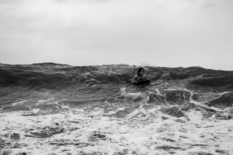 two men ride the surfboards on top of the ocean waves