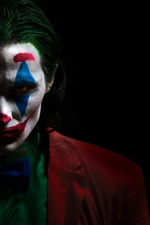 a man in red suit with clown face paint