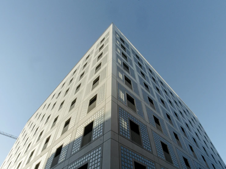 a very tall building with a stop sign below it