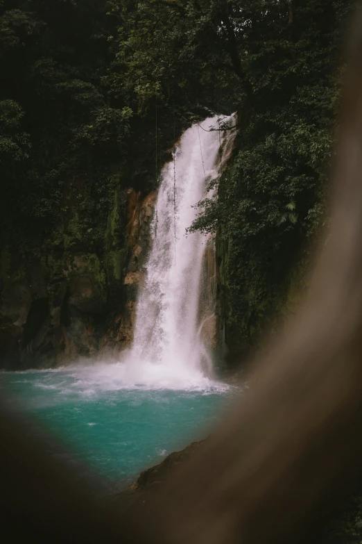 a waterfall is seen behind a human face