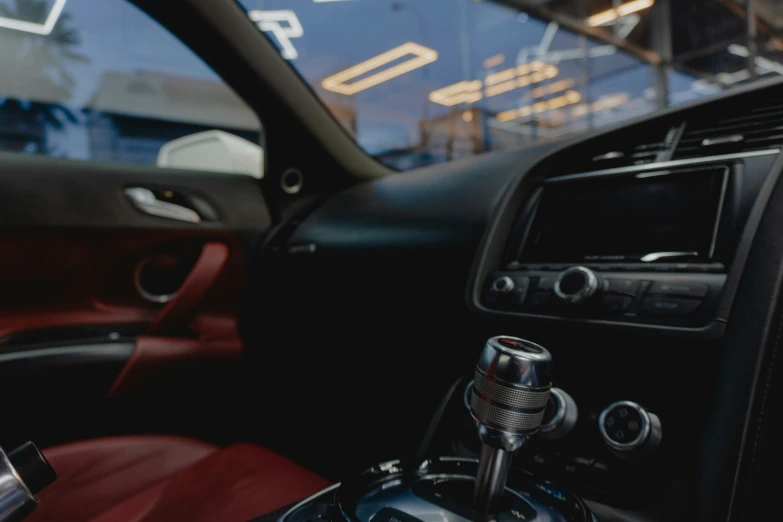 a car dashboard with red seats and control controls