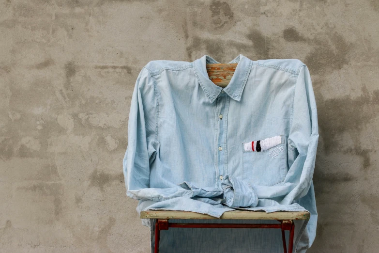 an ironing board sitting up against a wall