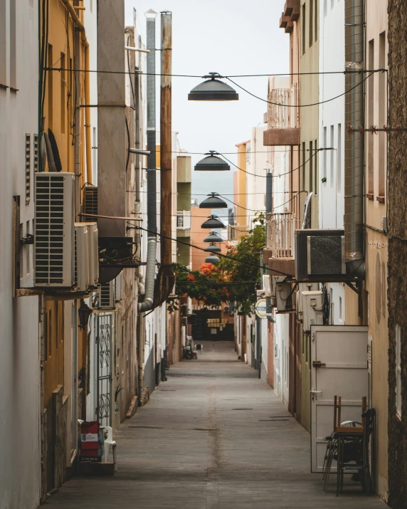 a narrow street with a number of buildings on either side