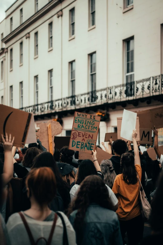 large group of people standing in the street protesting for justice