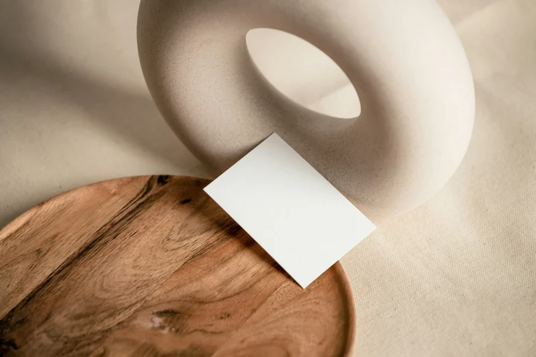a ceramic donut and paper on a wooden table