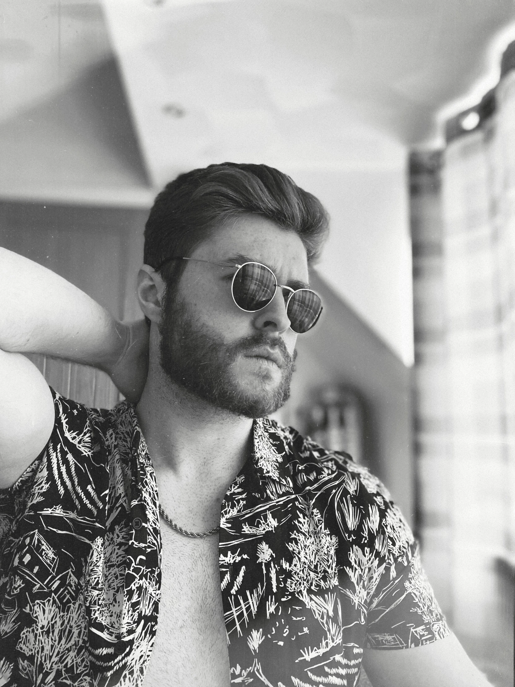 a man in a hawaiian shirt with sunglasses