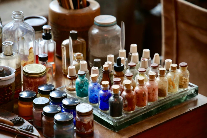 various bottles filled with liquid are on a small table