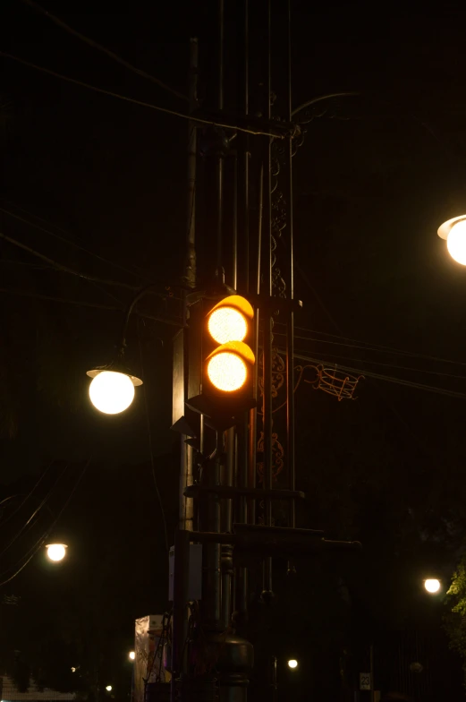 a pole with lights and a traffic light on it