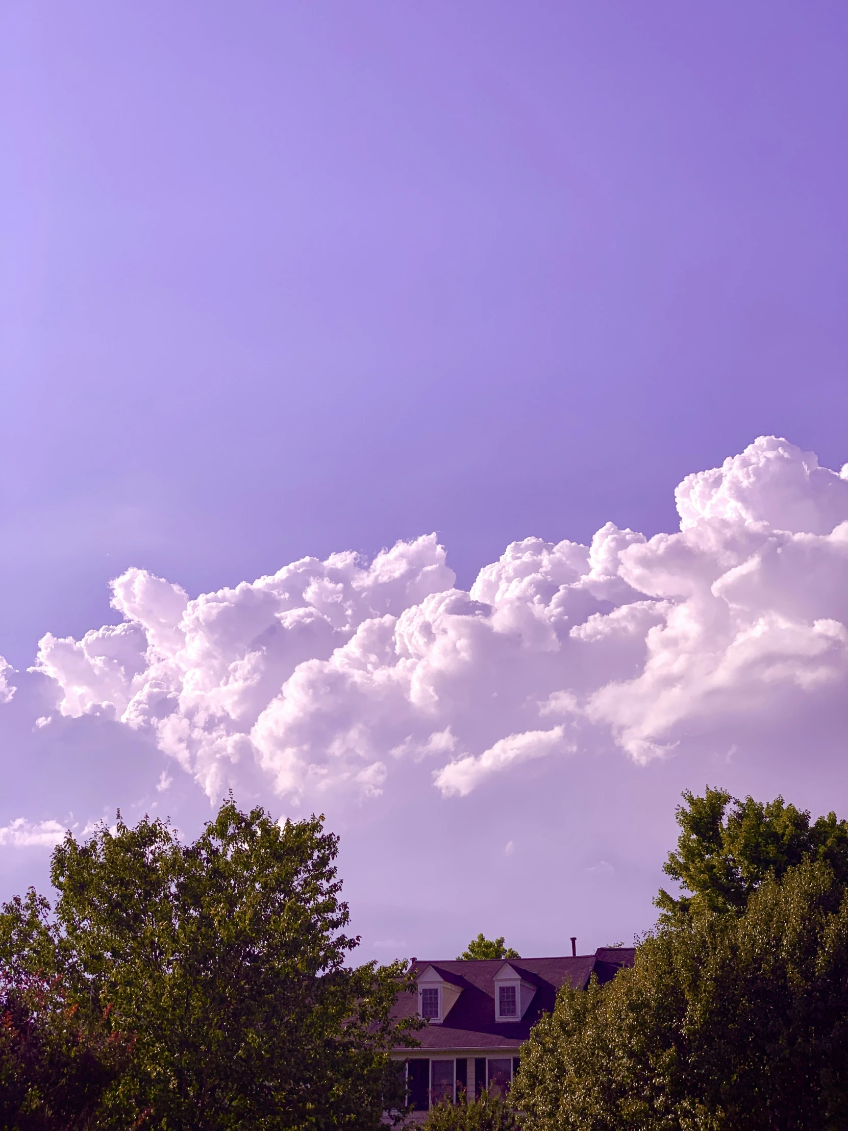 the sky in front of some very big clouds