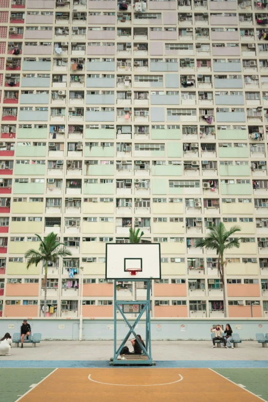 an apartment building has a basketball hoop in front