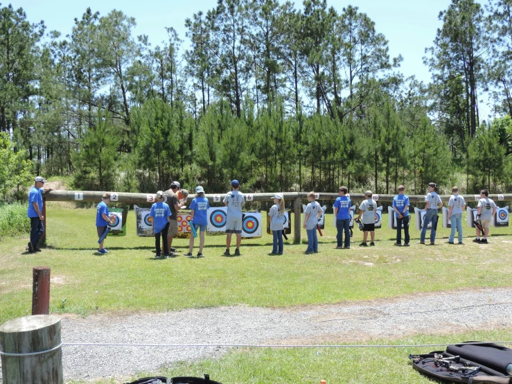 a group of people standing on top of a field with shields