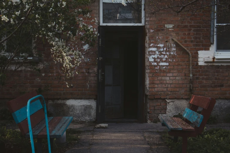 an image of two empty benches in front of a building