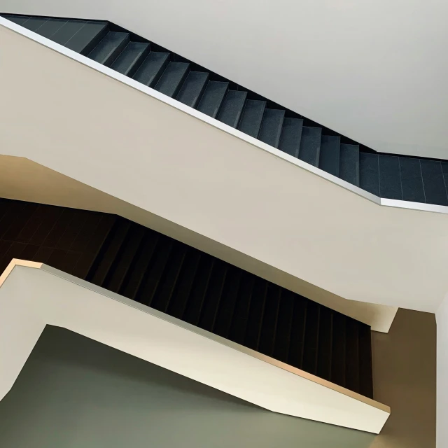 a stairwell with a black roof and stairs