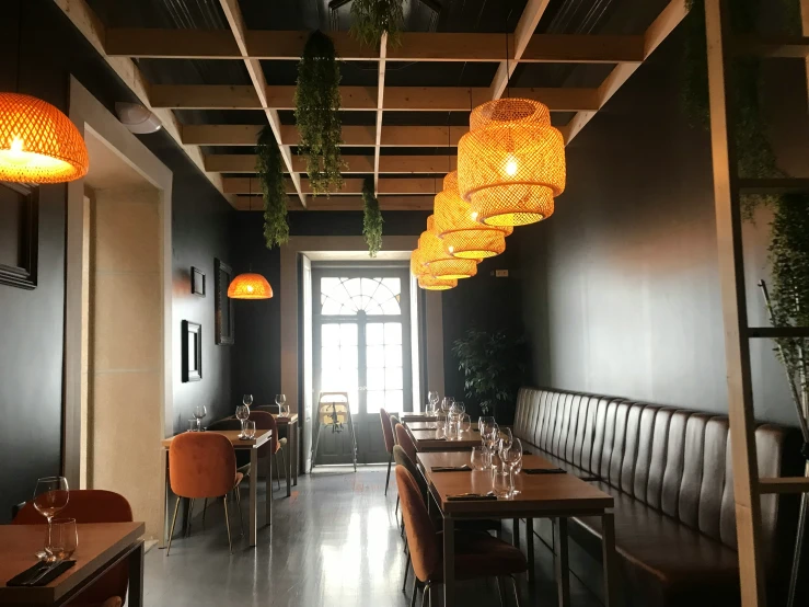 a restaurant with dark walls and wooden tables