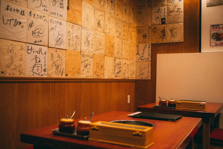 a room with a wooden table and several writing on the wall