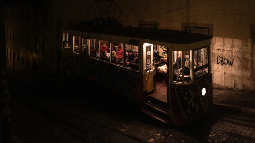 a trolley car filled with passengers in a dark tunnel