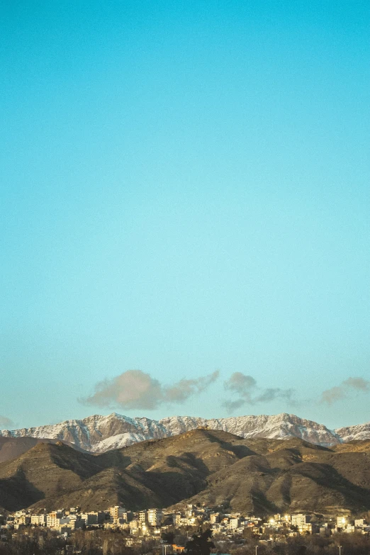 two kites fly over a snowy mountain landscape