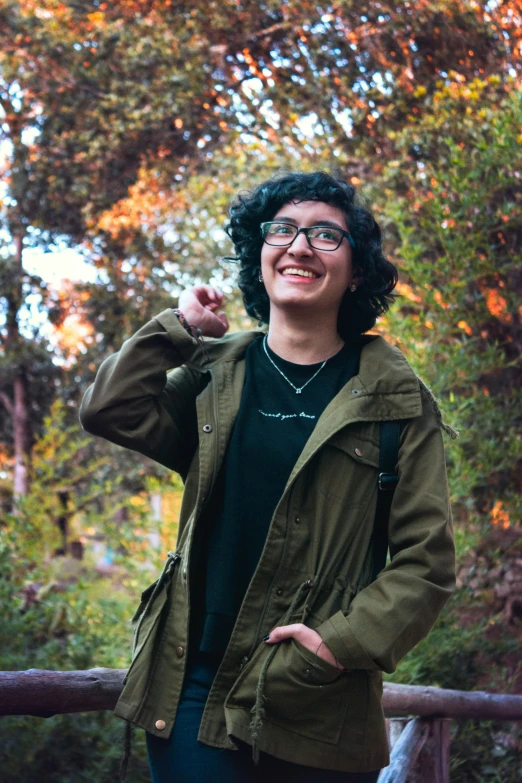 a woman in glasses is standing on a bench