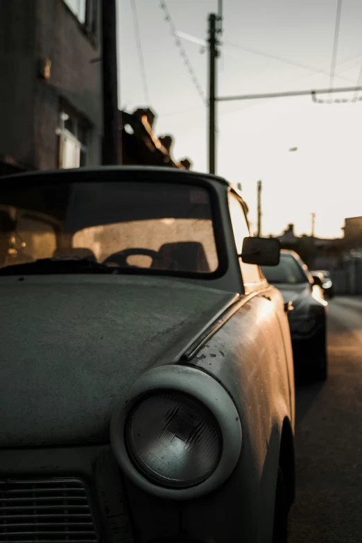 there is an old car parked on the street