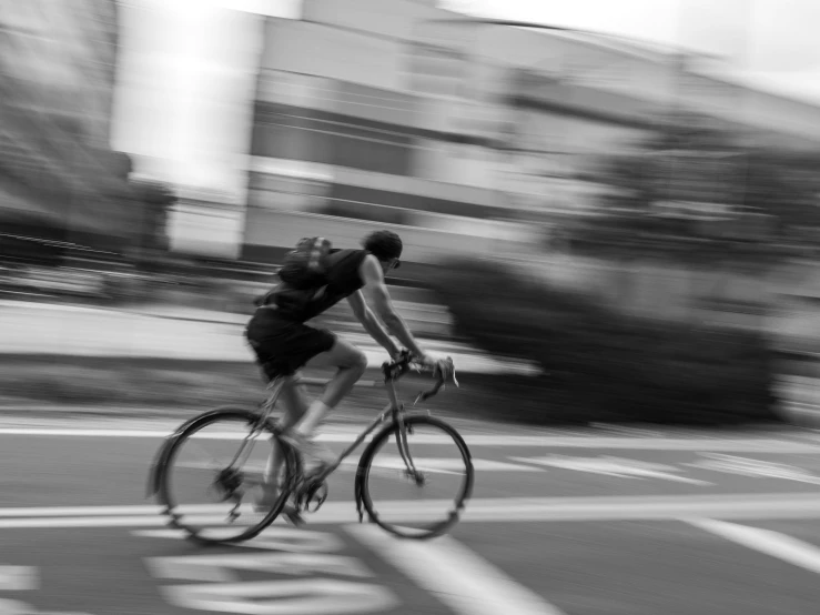 man on a bicycle riding down the street