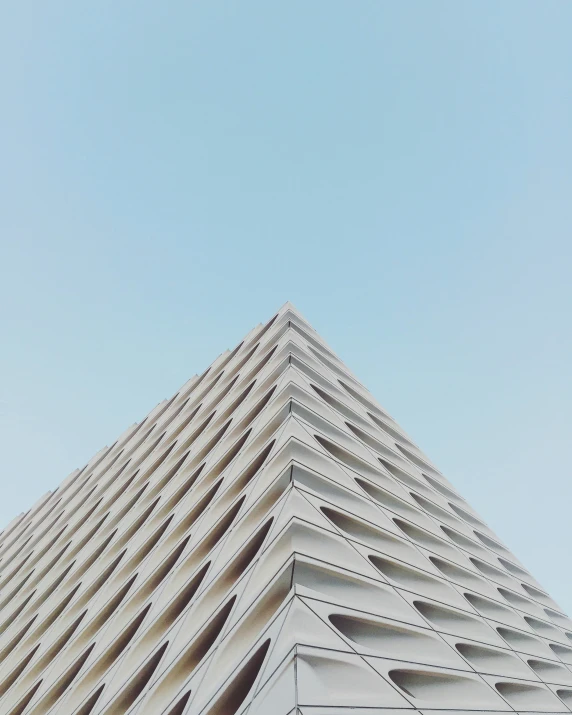 a tall white building under a blue sky