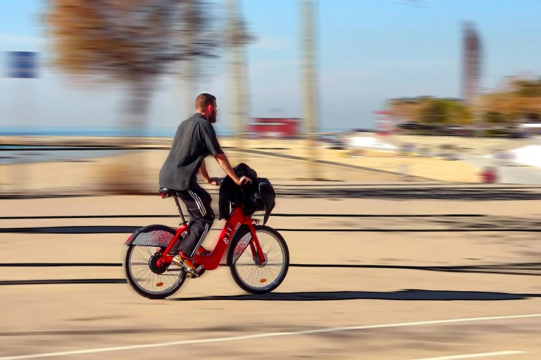 a man rides a bike on an empty street