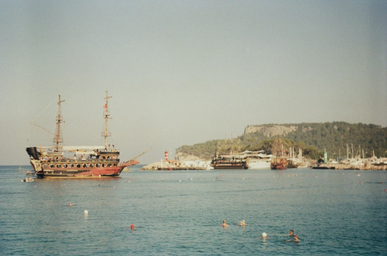 a large pirate ship sailing near a small island