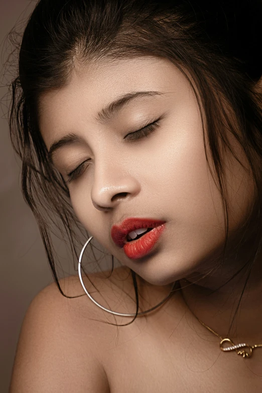 a beautiful asian girl with red lipstick and hoop earrings