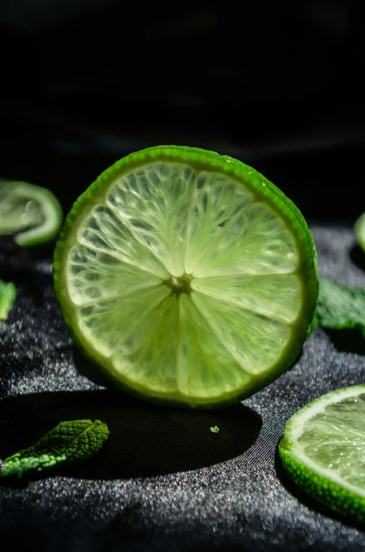 a lime half is surrounded by leaves