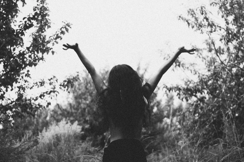 a woman in black shirt standing outside in the grass