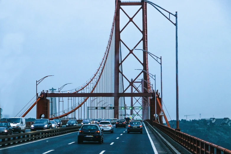 a long bridge with many cars passing by on a road