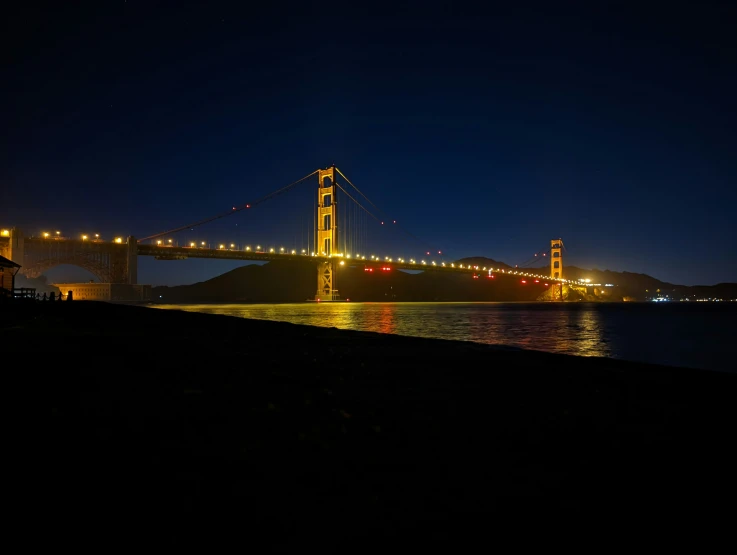 a big bridge on a river in the night