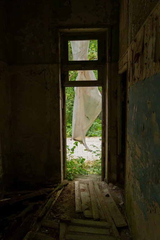an open doorway leading into a creepy building