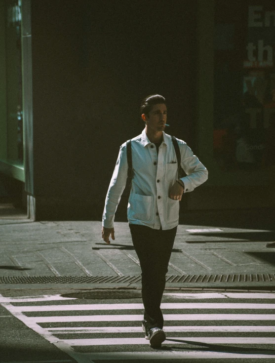 a man walks down a street with no shoes