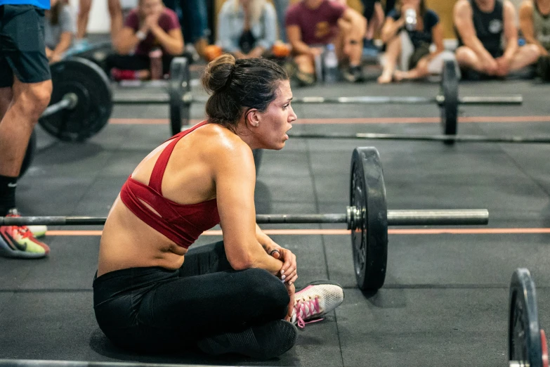 a woman sitting on the floor in front of two plates