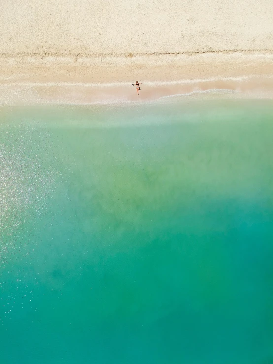 an aerial view of a sandy beach near the water