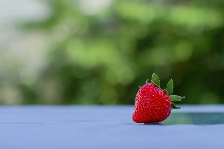 a ripe, strawberry that has just been picked