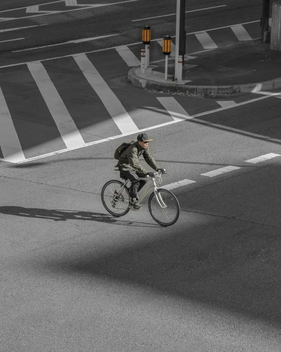 a person is riding on a bicycle across the street